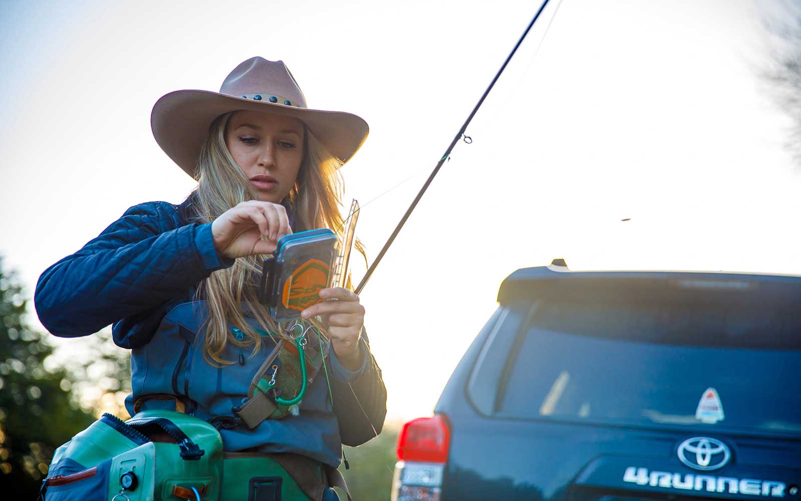 Morgan "Mo" Prater prepares her rod for winter fly fishing in the Lower Mountain Fork River, Beavers Bend Oklahoma